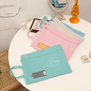 Detail of four colorful cartoon cat A4 document bags with sturdy handles and zippers