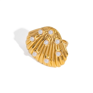Close-up of a gold shell-shaped ring set with multiple white pearls on a white background