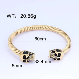 Detail view of gold braided stainless steel cuff bracelet with skull heads and dimensions