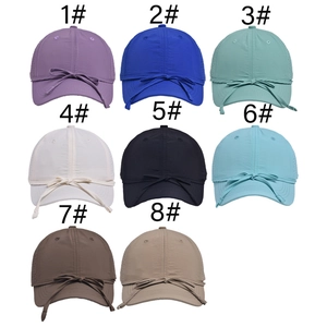 Detail view of quick-dry baseball caps in eight solid colors with bow decoration