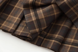 Close-up of brown plaid fabric showing detailed stitching and high-quality weave texture