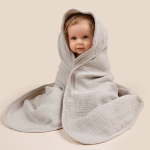 Macro detail of breathable light grey multi-layer cotton muslin fabric for baby hooded towels