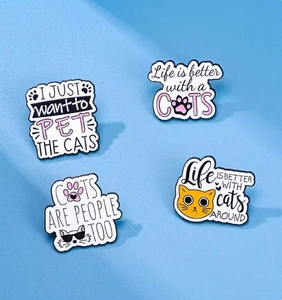 Set of four cartoon cat enamel pins featuring cute feline designs and playful quotes