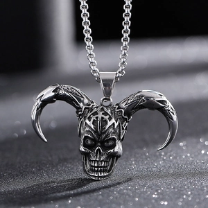 Macro shot of a silver gothic ram skull pendant with detailed curved horns on metal chain