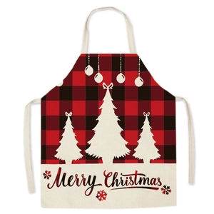 Detail of red and black plaid Christmas apron with Merry Christmas text and tree pattern