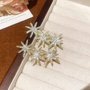 Macro detail of star-shaped hair clip with sparkling crystals in a velvet jewelry box