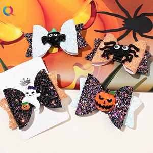 Close-up of Halloween sequin bow hair clips featuring ghost, pumpkin and spider designs