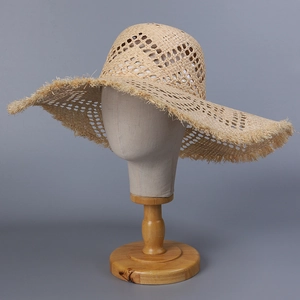 Handwoven raffia sun hat with wide brim and fringe detail for summer beach vacation