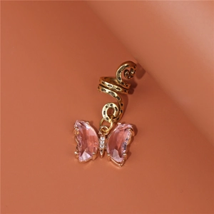 Detail of golden spiral dreadlock clip with a pink crystal butterfly pendant