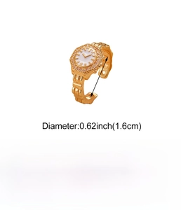 Detail view of a vintage gold clock ring with pink rhinestones and copper watchband texture