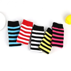 Flat lay of five pairs of colorful striped knee-high socks in cotton knit fabric