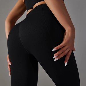 Detailed macro view of the black honeycomb textured high-waisted yoga leggings