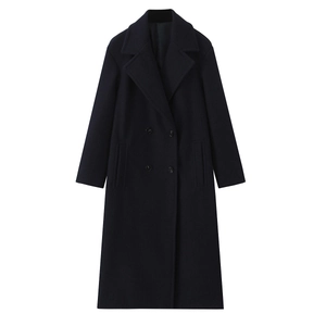 Detailed view of the black wool coat featuring double-breasted buttons and classic lapels