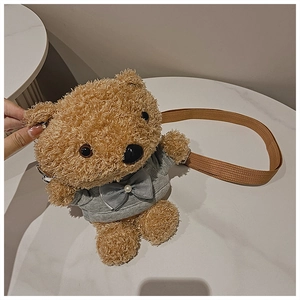 Close-up of teddy bear plush crossbody bag with grey sweater and pearl bow details