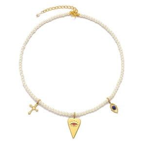 Detail of pearl necklace featuring gold heart eye pendant and blue gemstone charms