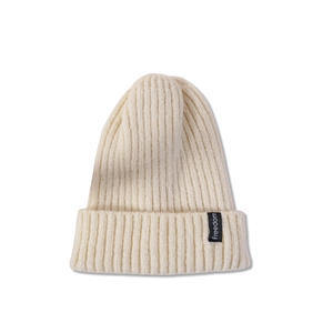 Close-up of cream ribbed knit beanie with a Freedom textile label on the folded cuff