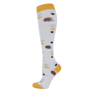 Detail of white compression calf socks with yellow accents and hedgehog patterns