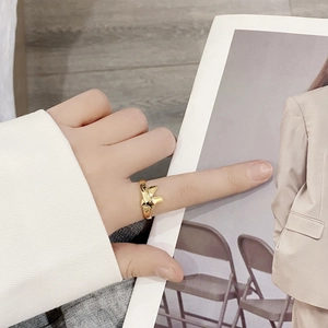 Elegant 925 sterling silver bow ring in gold finish on female model's finger