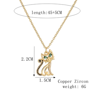 Detail view of a hollow cat pendant with size specs and green zircon eye settings