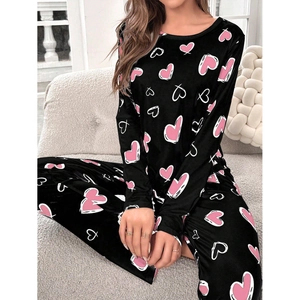 Detail of long sleeve heart print pajama set in black with pink and white heart patterns