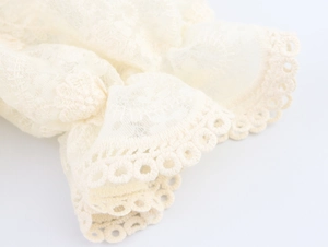Détail des poignets en dentelle ivoire avec broderie en tulle et bords ajourés
