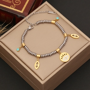 Exotic stainless steel beaded bracelet with evil eye charms and turquoise accents