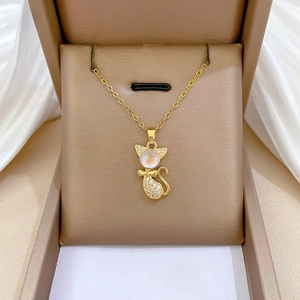 Detailed view of luxury cat pendant with opal head and pavé crystals in gold box