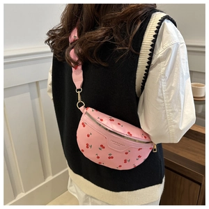 Detail of pink cherry print crossbody bag with adjustable strap and fashion label detail