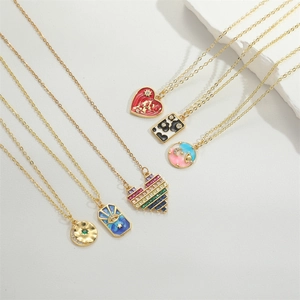 Gold necklaces set featuring ocean star, heart, and evil eye pendants on white background