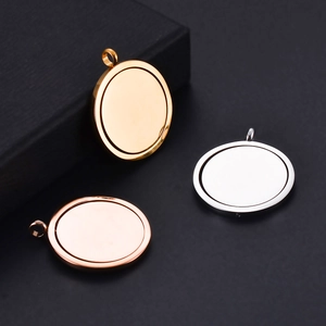 Minimalist spinning circle pendants in gold, rose gold and silver on black background