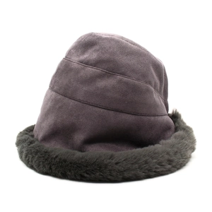 Detail of purple winter bucket hat featuring thick grey faux fur trim and suede texture