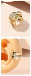 Double-layered gold ear cuff with polished wide band and pavé crystals on model's ear