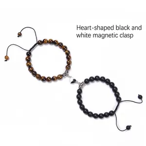 Detail of heart magnet clasp connecting tiger eye and matte black beaded couple bracelets