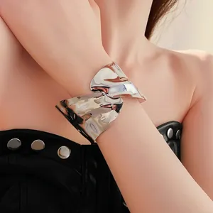 Wide irregular pleated metal open cuff bracelet with high-polish mirror finish on wrist