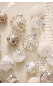 Detailed view of champagne and white Christmas balls with pearls and gold glitter