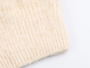 Close-up of ribbed knit texture with soft mohair fibers in cream white color