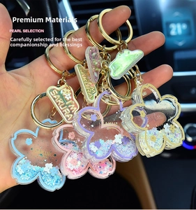 Detail of colorful Sakura cherry blossom acrylic liquid keychains with shiny sequins