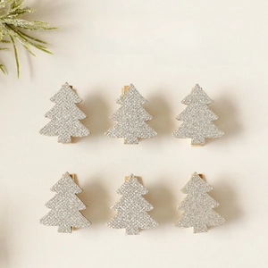 Set of 6 silver glitter Christmas tree wooden hair clips on a warm beige background