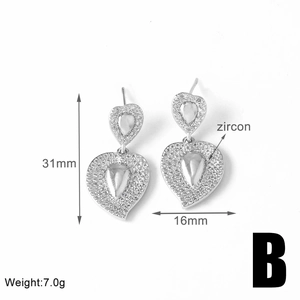 Detailed size view of silver heart earrings with zircon stones, 31mm length by 16mm width