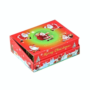 Creative Christmas candle in a festive red gift box with Santa Claus and snowman patterns