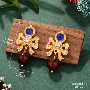 Detail view of retro bow earrings with red pearls and blue gems including size dimensions