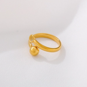 Detailed shot of golden minimalist open ring with spherical bead design on polished band