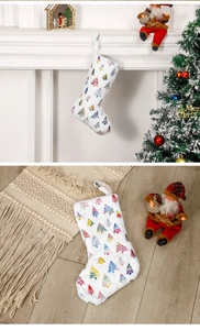 White plush Christmas stocking with colorful tree patterns hanging on a fireplace mantel