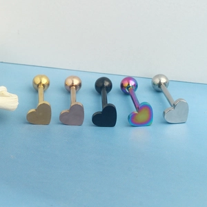 Detail view of heart-shaped stainless steel tongue rings in five distinct metallic colors