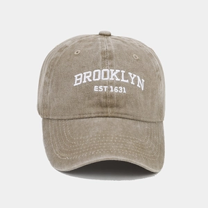 Detailed close-up of BROOKLYN EST 1631 embroidery on khaki washed cotton baseball cap