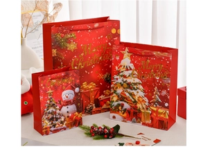 Macro detail of red Christmas gift bags with gold Merry Christmas foil and glitter
