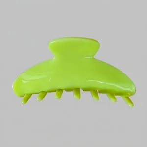 Detailed side view of large neon green acetate hair claw clip with matte resin finish