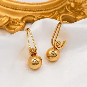 Elegant 18k gold plated geometric spherical drop earrings on white satin fabric