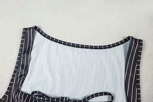 Close-up of the striped two-piece set neck binding and fine stitching detail