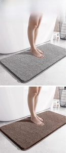 Detailed view of high-density flocked microfiber bath mats in dark grey and brown colors